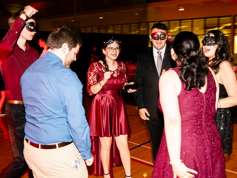 A group of students have fun at the homecoming dance.