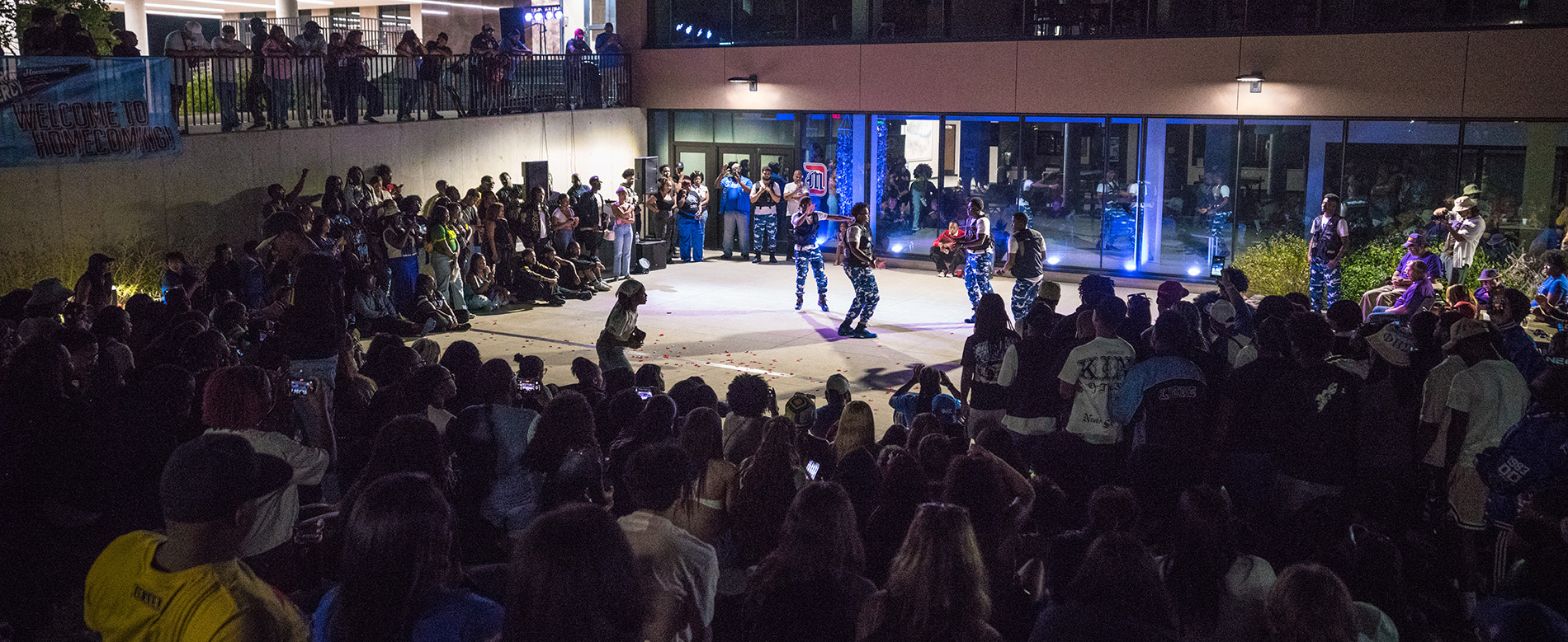 A large group gathers by the Student Union to watch the yard show at Homecoming.