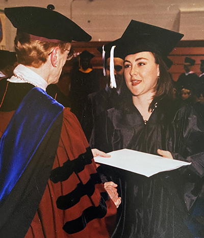 A photo of Michelle Murphy at her graduation from UDM.