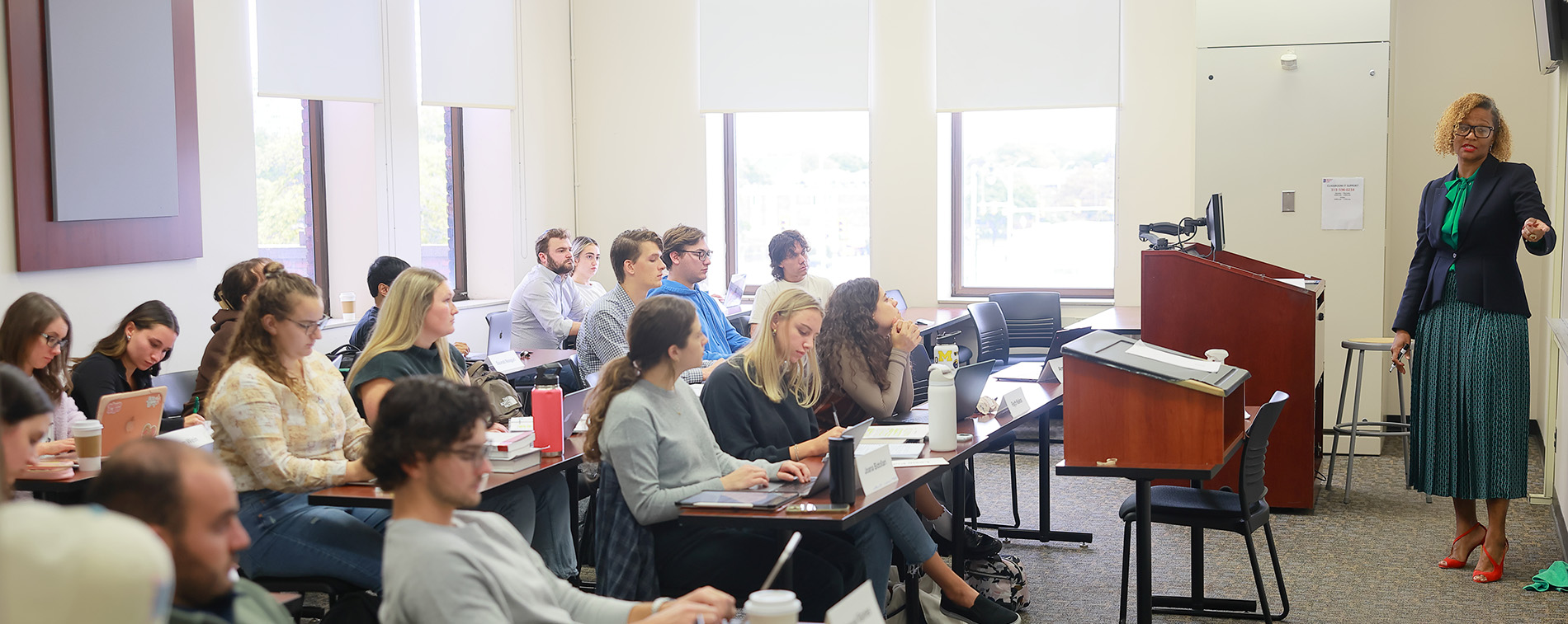Law students sit in a classroom while a professor teaches.