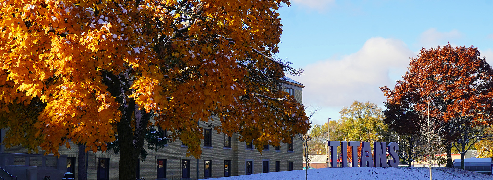 The Titans sign on the McNichols Campus during a snowy fall day.