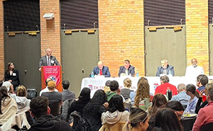 Steven Meerschaert presents at a podium during an event.