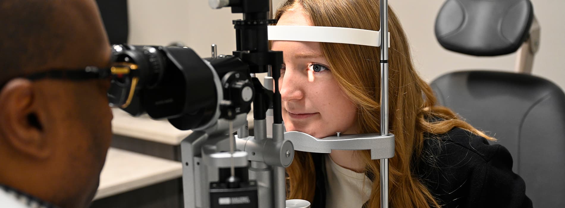 A woman has her eyes examined.
