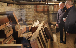 Two men survey the basement at UDM Law.