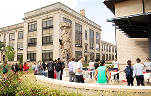 Students have fun at RecFest by playing games and climbing a rock wall.