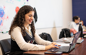 A student works on her laptop.