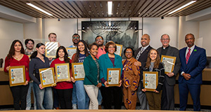 TENN and city councilmembers pose for a photo with the Spirit of Detroit award.