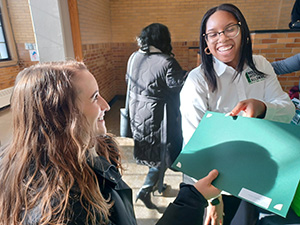 Chelsea Manning receives an award from a woman.