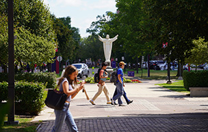 Students walk around Sacred Heart Square on the McNichols Campus
