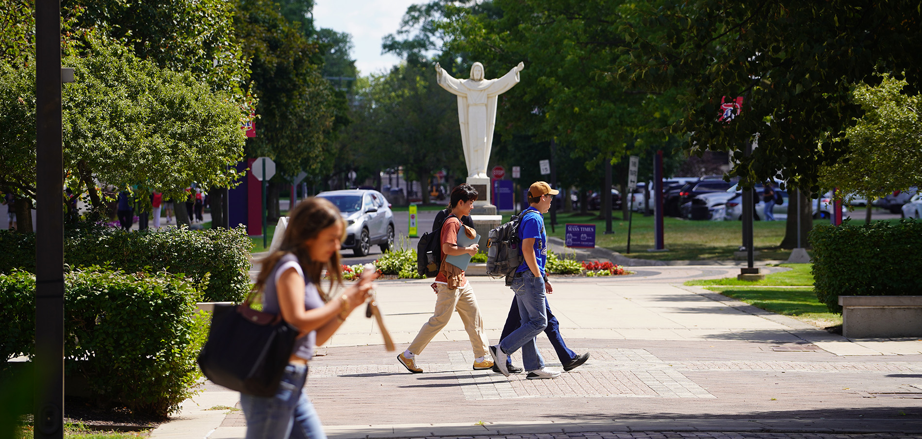 Students walk around Sacred Heart Square on the McNichols Campus