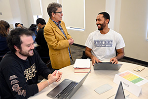 a law professor interacts with several law students in a classroom.