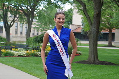 Grace Hanke poses for a photo near the Fisher Fountain.