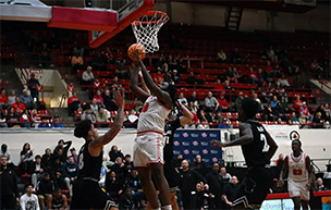 A Titans men's basketball player drives to the basket during the game against Milwaukee.