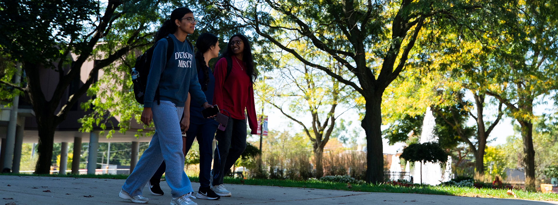 A group of students walk on UDM's McNichols Campus.