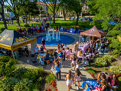 Students on the McNichols Campus gather around the fountain during Titan Fest.