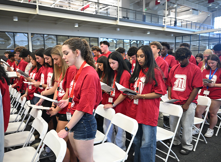 Students follow along during first year convocation.