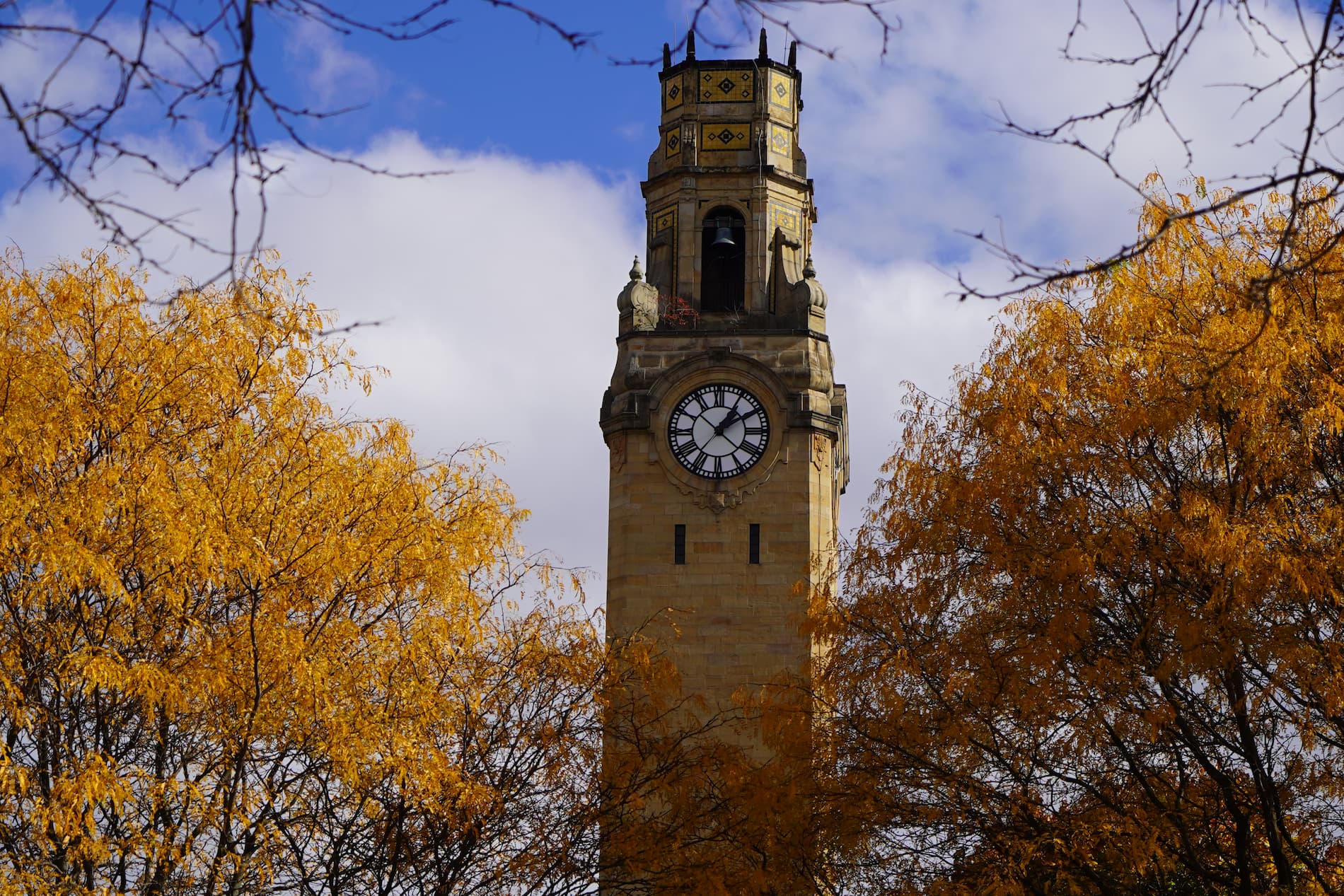 UDM clocktower amid fall foliage