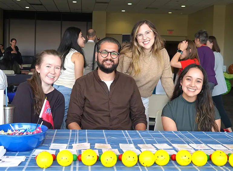 leaders of the psychology clinic smiling at the well-being fair