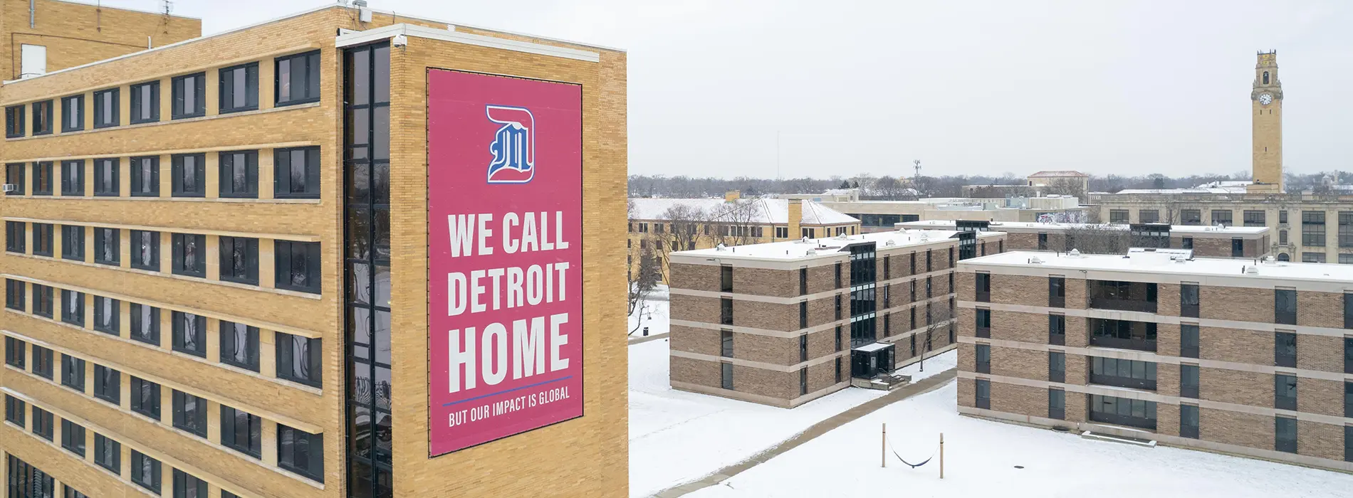 UDM McNichols campus - dorm with we call detroit home banner on the side of the building