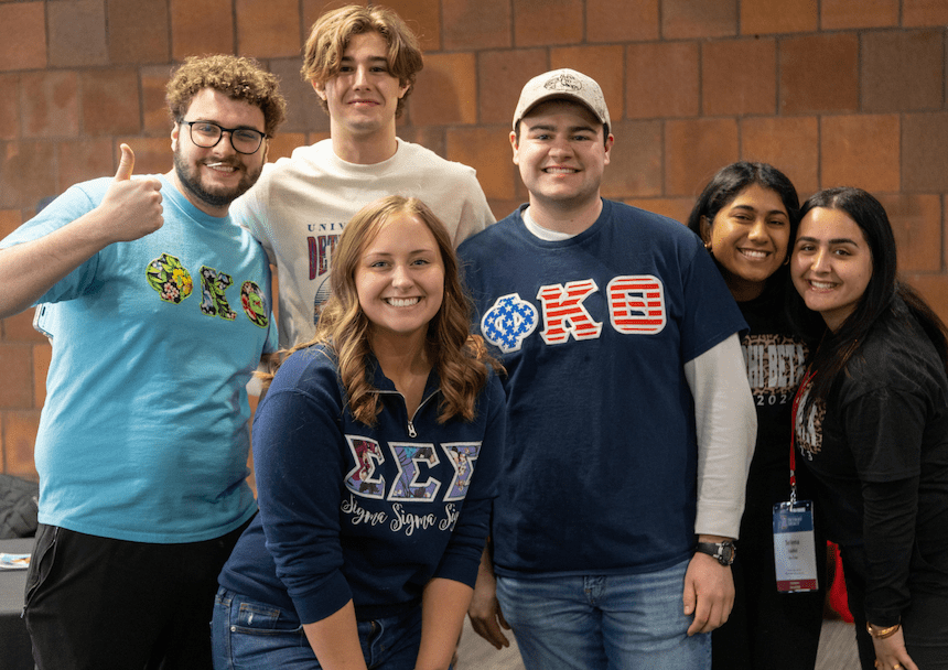 Fraternity and sorority members pose for a photo.