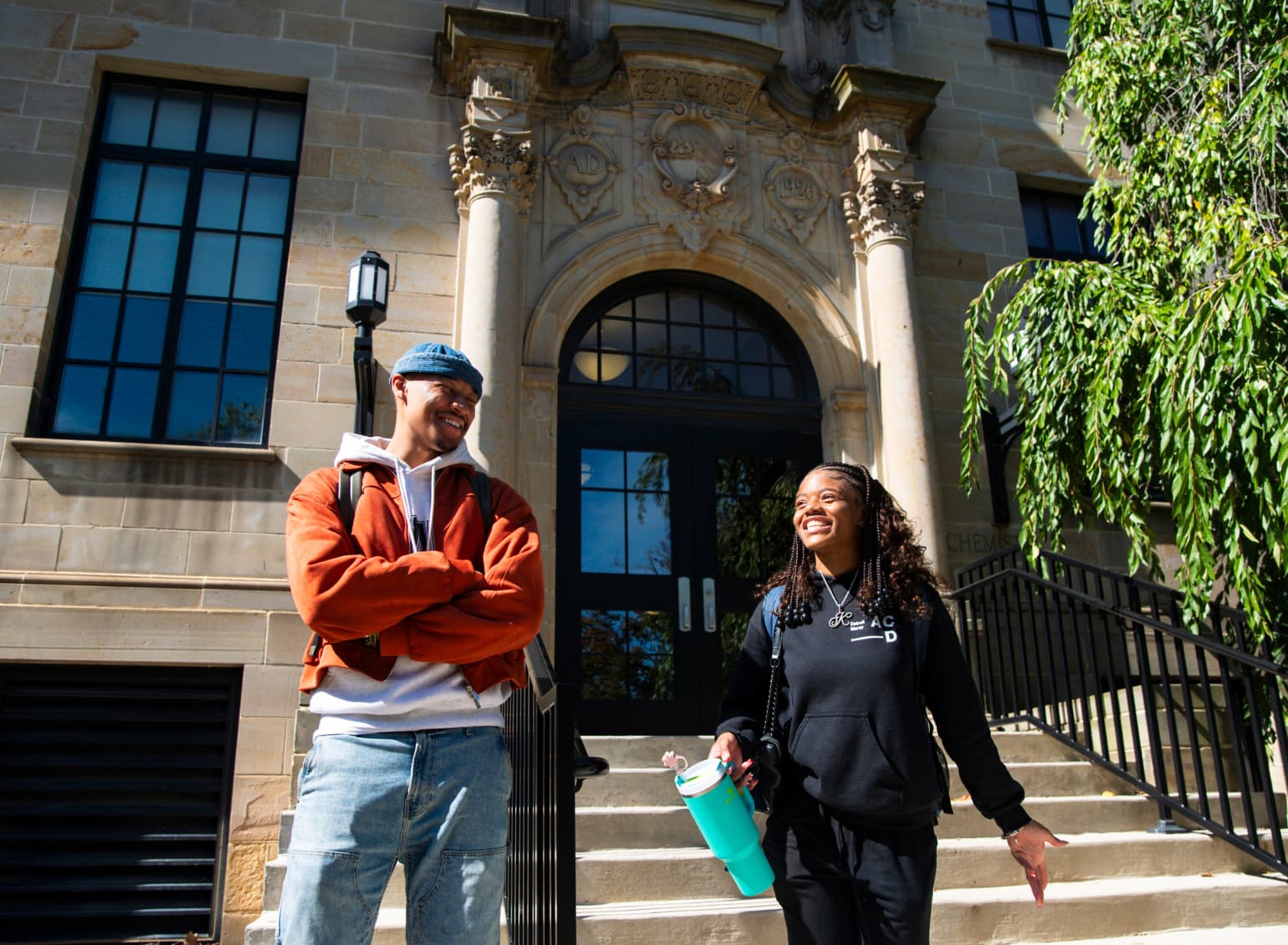 Students stand and talk outside of the Chemistry Building.