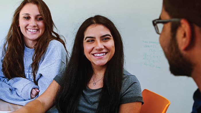 3 students with one smiling