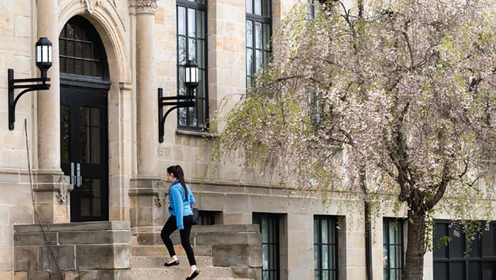 student walking into building