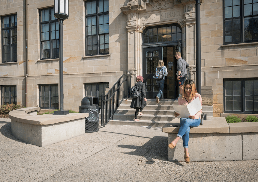 Students walk into the Commerce and Finance Building.