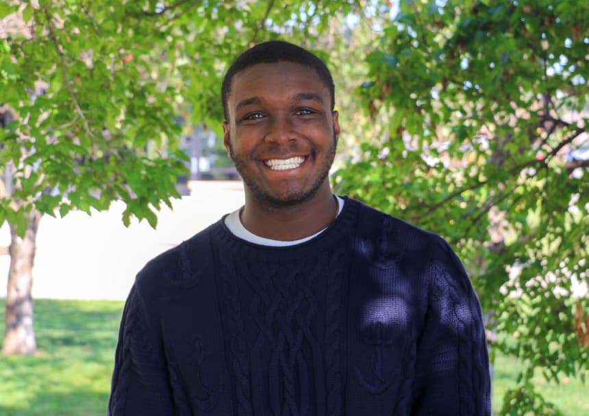 A male student smiles.