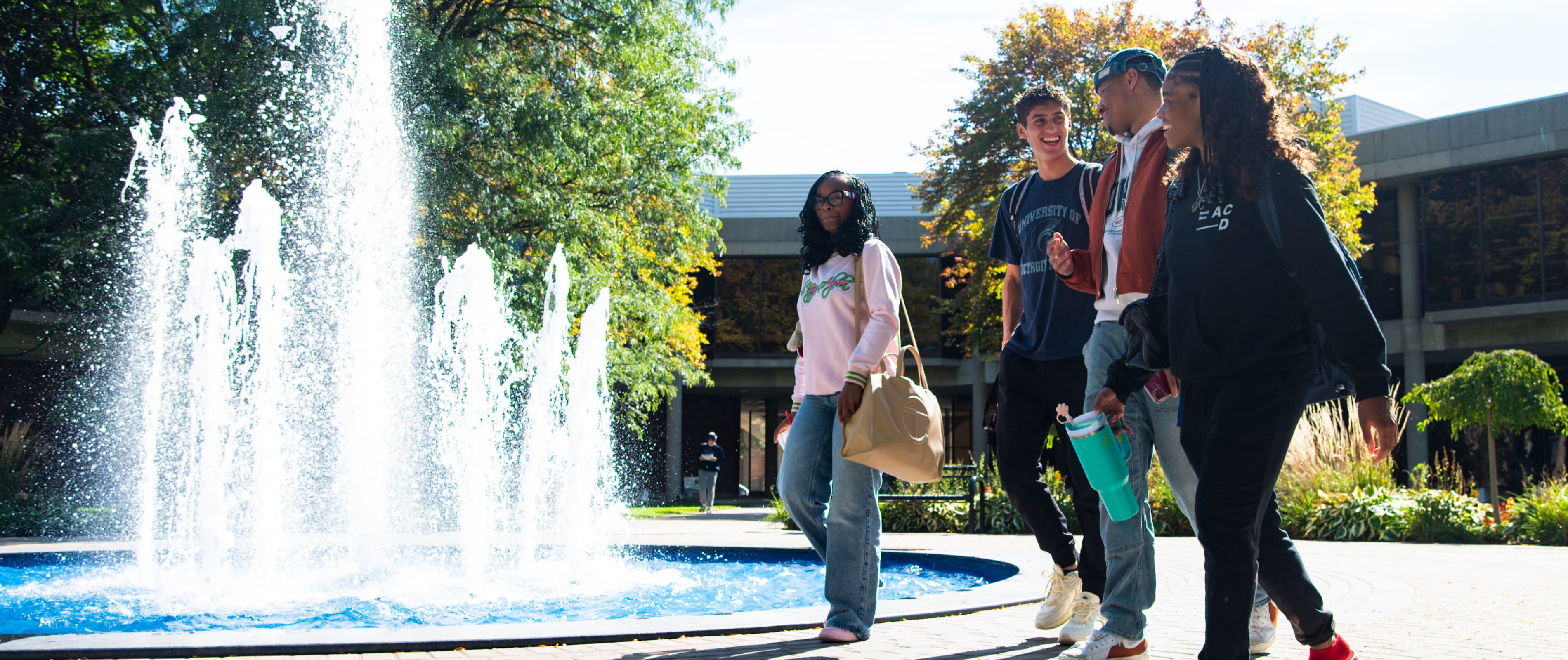 Students walk past the fountain on the McNichols Campus.