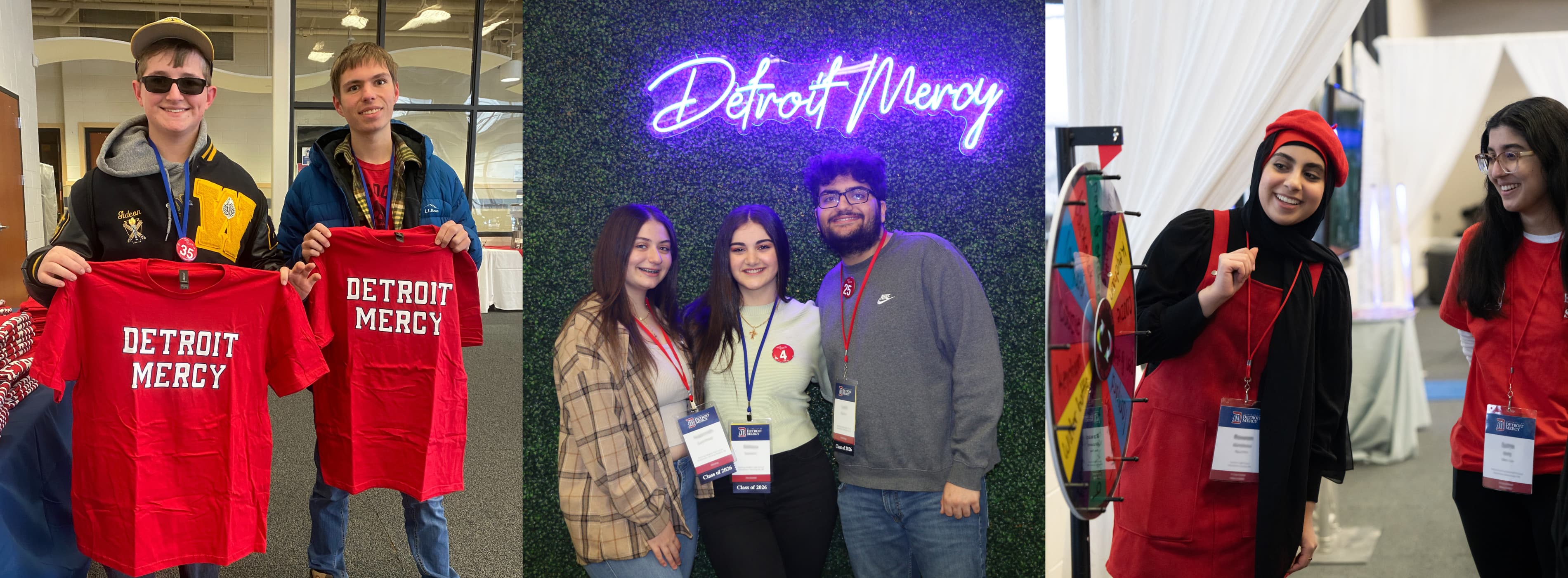 Students with T-shirts, posing in front of an LED Detroit Mercy sign and spinning a prize wheel