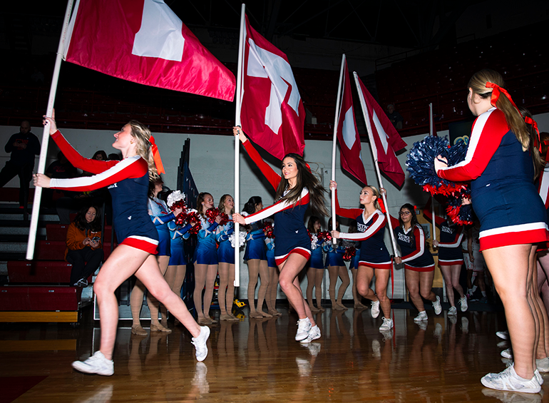 Titans cheerleaders run out on the court before a basketball game.