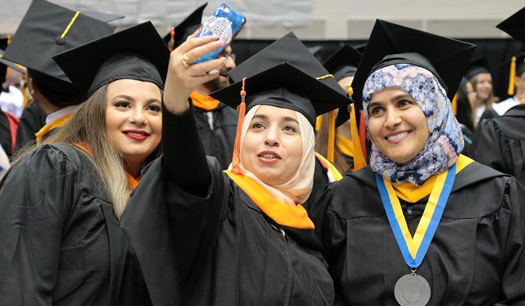 2017 Detroit Mercy graduates posing for a selfie