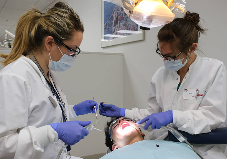 Students working at dental clinic.