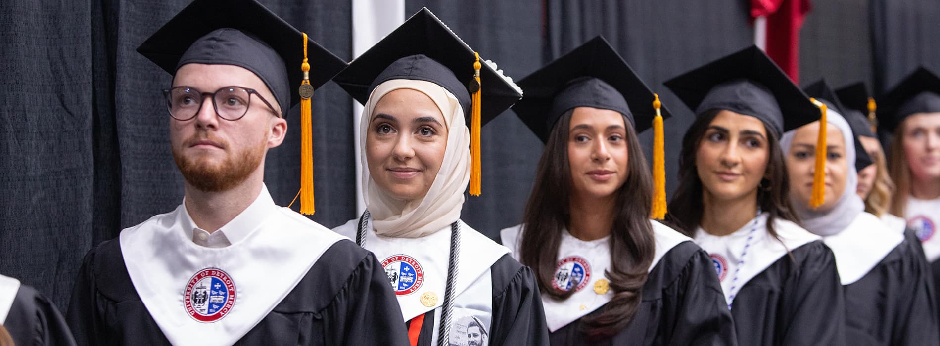 graduating students in full cap and gown