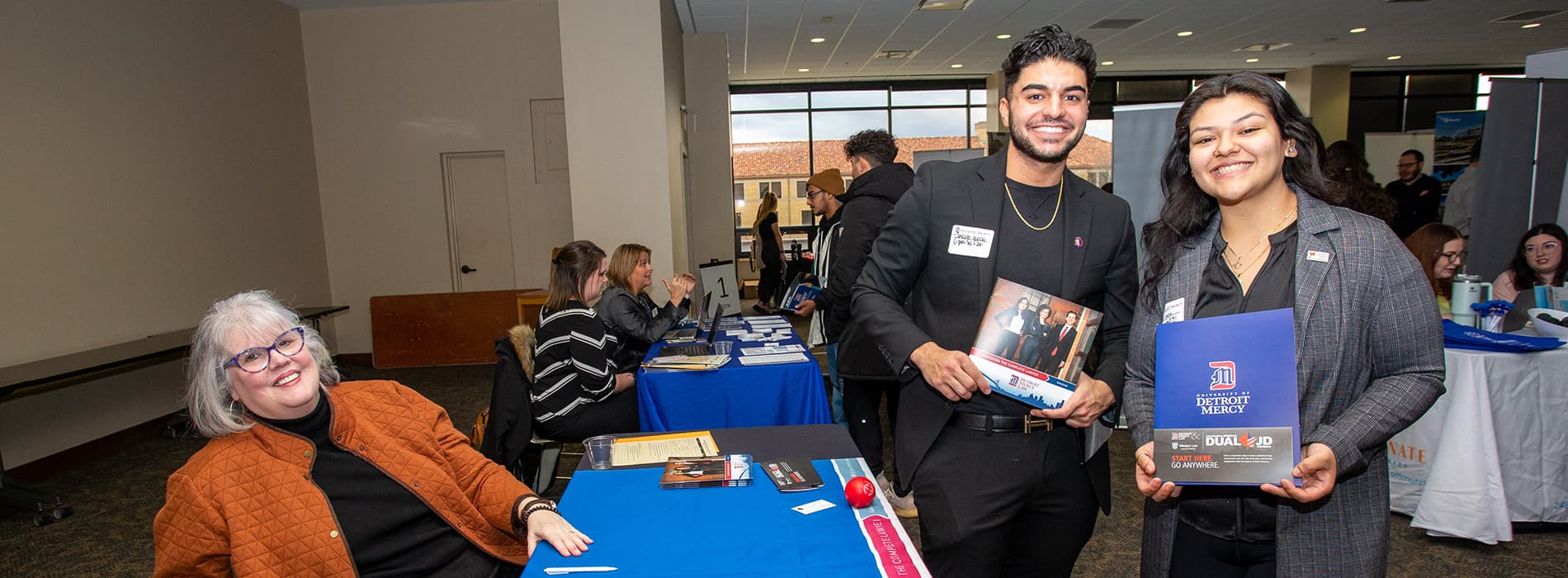 student talking to a company at career fair