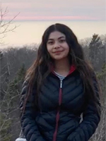 Ayanna Mendieta sitting on a bridge railing