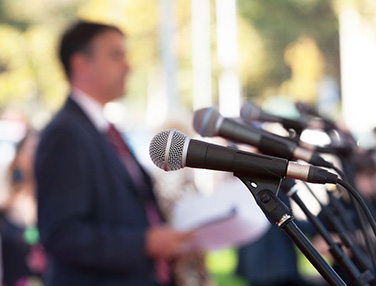 microphones and blurry guy in background