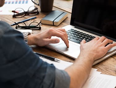 guy's hands on a laptop