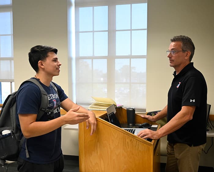 student and prof chatting