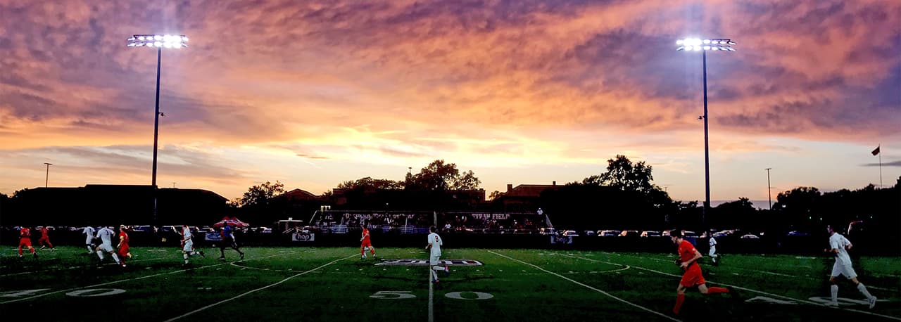 soccer players on field at night