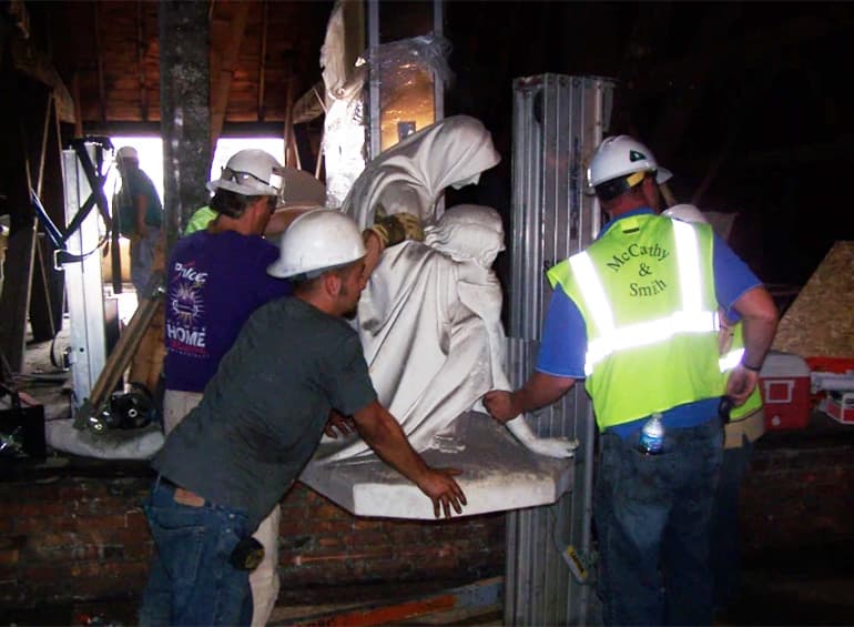 Pieta statue with moving people