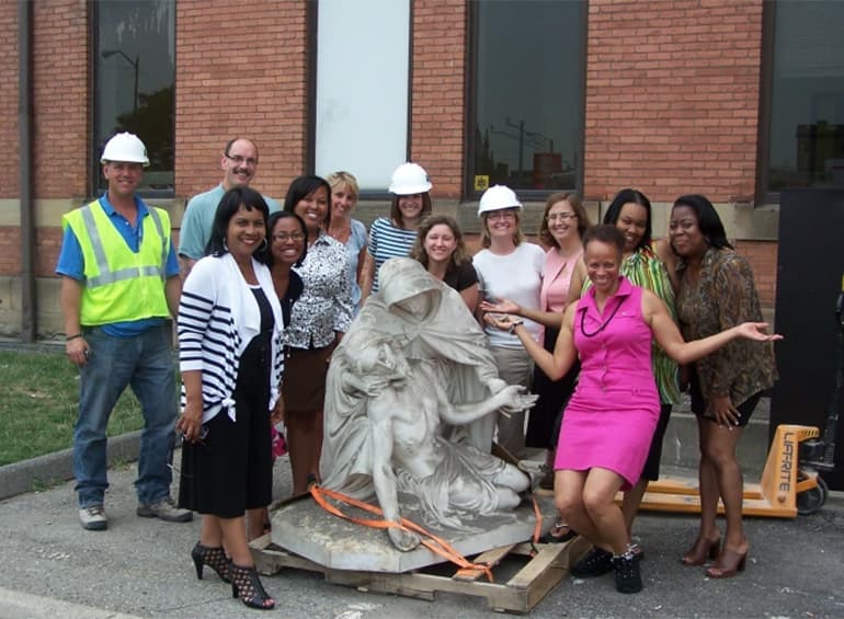 Group of people around Pieta statue