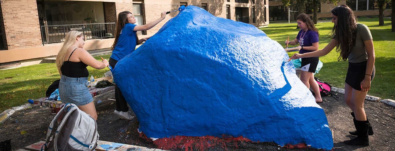 Students standing in front of The Rock.