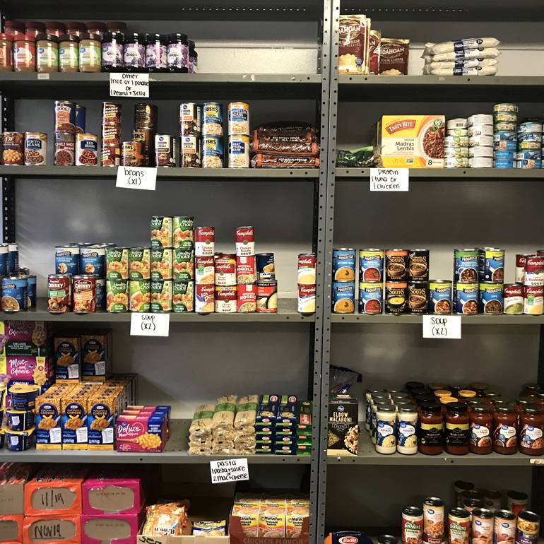 Static image of one of the food pantry shelves operated by The Hive.