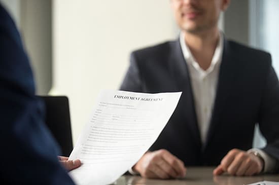 man handing resume to potential employer