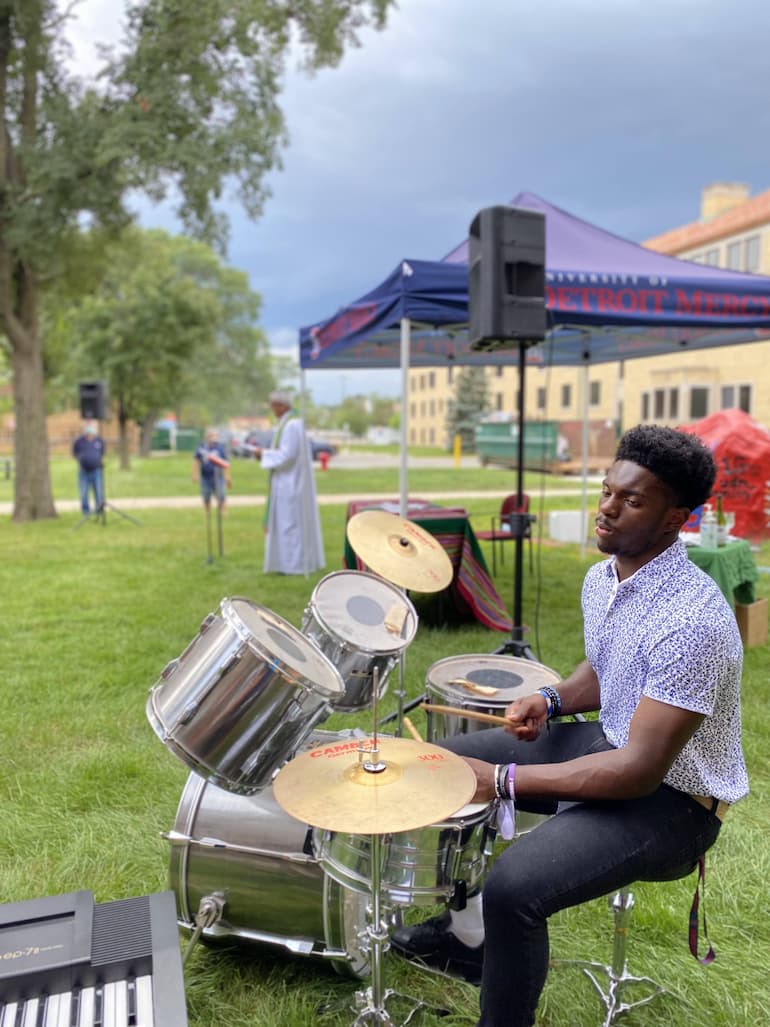 Photograph of student drumming during Mass.