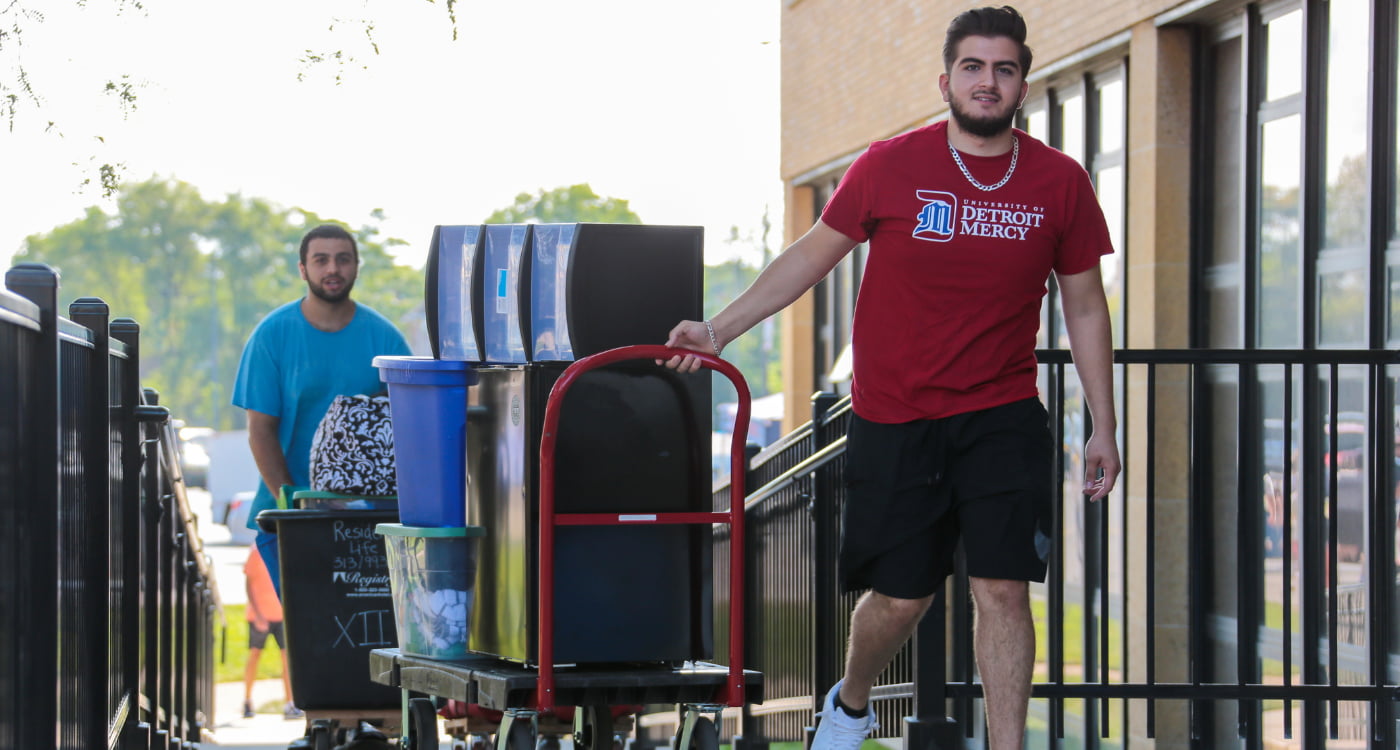 Two students move into a residence hall.
