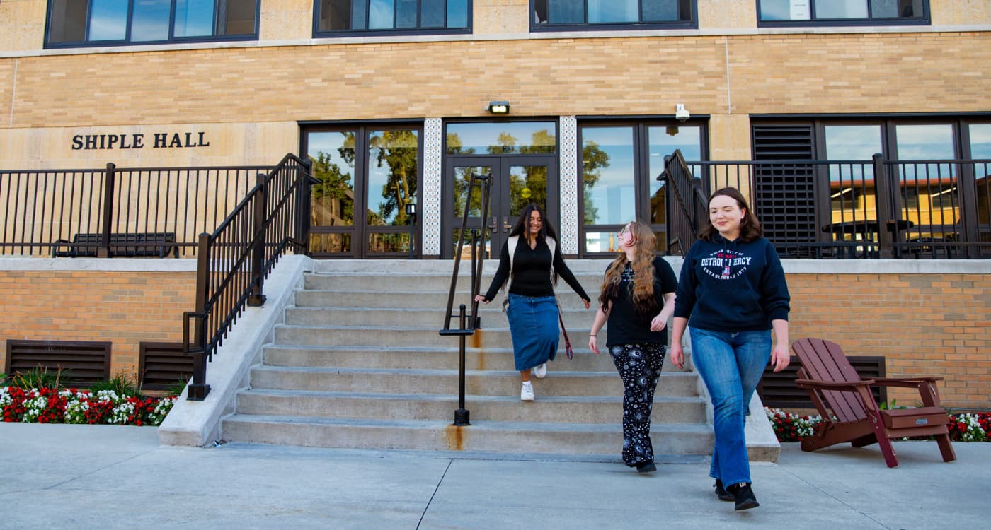 Three students walk out of Shiple Hall.