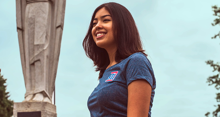 A student smiles on campus.